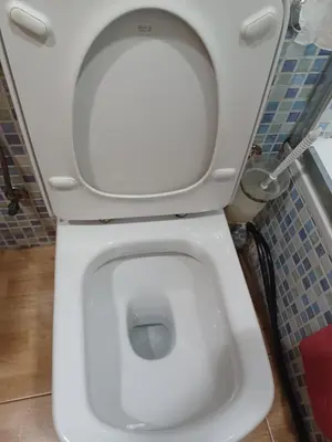 a white toilet with the lid up in a bathroom at Casa Ferrer Barcelona in Hospitalet de Llobregat