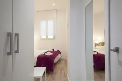 a bedroom with two beds with purple blankets at Habitat Apartments Blanca in Barcelona