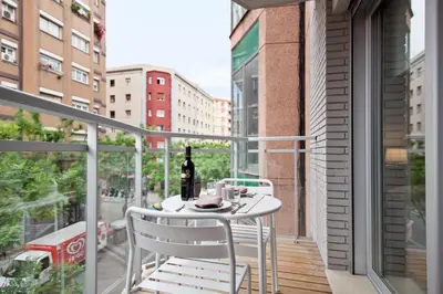 a balcony with a table and a bottle of wine at Habitat Apartments Blanca in Barcelona