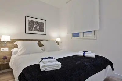 a bedroom with a bed with towels on it at Habitat Apartments Blanca in Barcelona