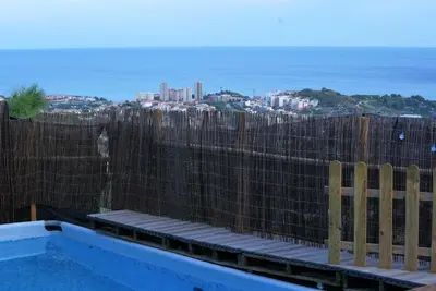 a wooden fence with a view of a city at AAA View Private Terrace Outdoor Heated Hot Tub Family Fun in Badalona