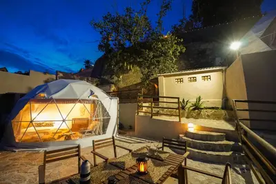 a gazebo with a table and stairs at night at AAA View Private Terrace Outdoor Heated Hot Tub Family Fun in Badalona