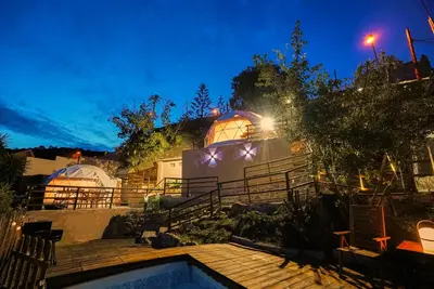 a house with a swimming pool at night at AAA View Private Terrace Outdoor Heated Hot Tub Family Fun in Badalona