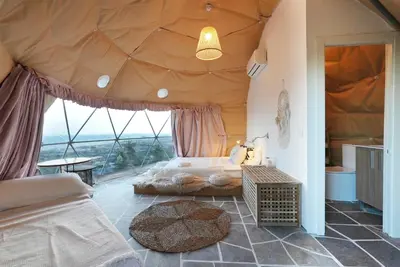 a bedroom with a large bed in a tent at AAA View Private Terrace Outdoor Heated Hot Tub Family Fun in Badalona