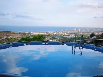 a large swimming pool with a view of a city at A+View Private Terrace Private Pool Family Fun in Badalona