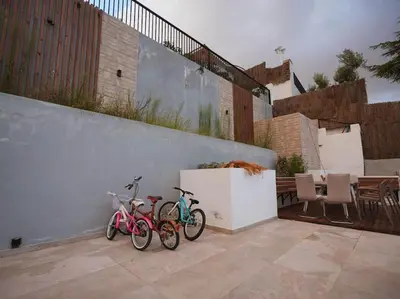 two bikes are parked next to a wall at A+View Private Terrace Private Pool Family Fun in Badalona