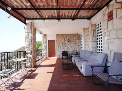 a living room with a couch on a patio at A+View Private Terrace Private Pool Family Fun in Badalona