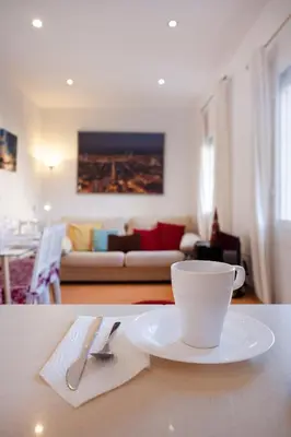 a coffee cup on a table in a living room at Cute Apartment in Sants Station with HBO & Alexa & AC in Barcelona