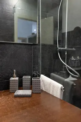 a bathroom with a shower and a counter with towels at Cute Apartment in Sants Station with HBO & Alexa & AC in Barcelona
