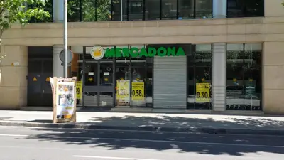 a store with a sign in front of a building at Cute Apartment in Sants Station with HBO & Alexa & AC in Barcelona