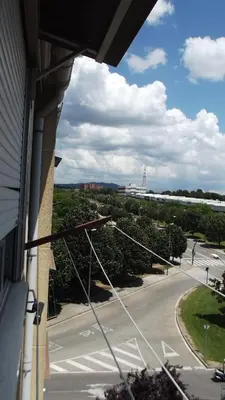 a view from a balcony of a street with a lighthouse at Apartamentos Atlas Terrassa I in Terrassa