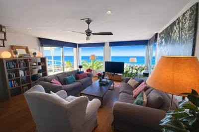a living room with a view of the ocean at Villa Sitges Altavista Amazing View South oriented Calm Area AC Beach 2 minutes Drive and 18 minutes Walk in Sitges
