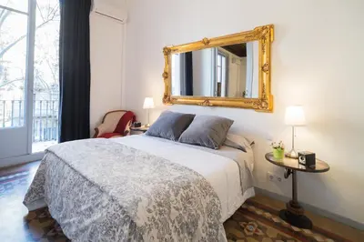 a bedroom with a bed with a mirror on the wall at Rafael Music Palace apartment in Barcelona