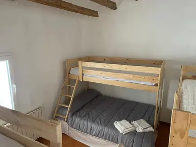 a bedroom with two bunk beds and a ladder at Cal Tomaset in Les Cabanyes