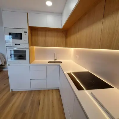a kitchen with white cabinets and a sink at Ancora Apartment in Vilanova i la Geltrú