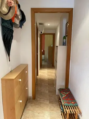a hallway leading to a room with a hallwayasteryasteryasteryasteryasteryasteryastery at Cunit Beach in Cunit