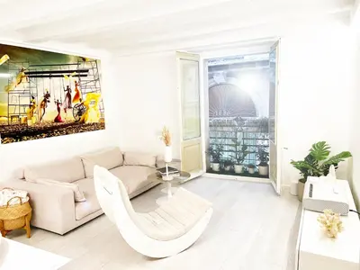 a living room with a couch and a table at White Apartment Barcelona in Barcelona