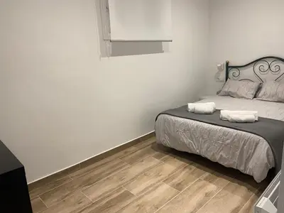 a bedroom with a bed with two towels on it at APARTAMENTO EN LA PLAYA in Pineda de Mar