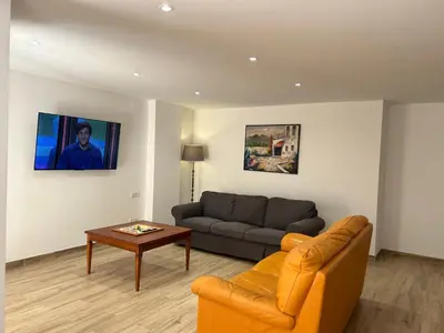 a living room with a couch and a table at APARTAMENTO EN LA PLAYA in Pineda de Mar