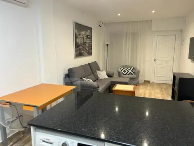 a living room with a couch and a table at APARTAMENTO EN LA PLAYA in Pineda de Mar