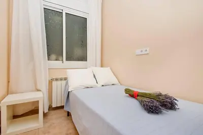 a small bedroom with a bed with a window at Glorias:Sagrada Familia 15 minutos - Playa 20 minutos in Barcelona