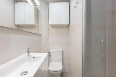 a bathroom with a toilet and a sink and a shower at Aparteasy - Bright, large and central apartment in BCN in Barcelona