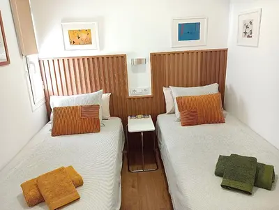 two beds sitting next to each other in a room at Comfortable apartment. Very central and quiet. in Barcelona