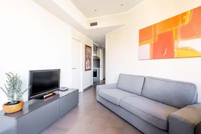 a small bedroom with a bed with a blue pillow at The Collection Barcelona - Eixample next to Paseo de Gracia modern 3BD in Barcelona