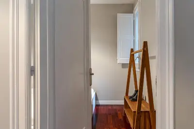 a room with a door and a wooden ladder at Canela Homes BARCELONA EIXAMPLE in Barcelona