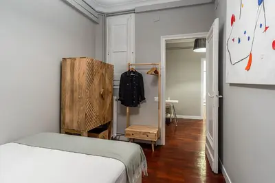 a small bedroom with a bed and a closet at Canela Homes BARCELONA EIXAMPLE in Barcelona