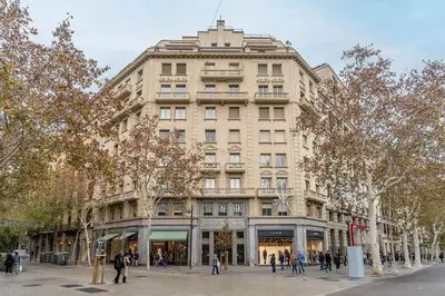 a large building with people walking in front of it at Canela Homes BARCELONA EIXAMPLE in Barcelona
