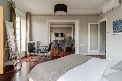 a bedroom with a bed and a table and chairs at Canela Homes BARCELONA EIXAMPLE in Barcelona
