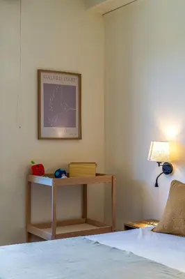 a bedroom with a bed and a table and a picture at Canela Homes BARCELONA MODERNISTA in Barcelona