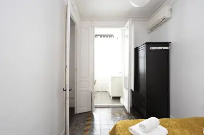 a bedroom with a black cabinet and a window at Canela Homes BARCELONA RAMBLA CAT in Barcelona