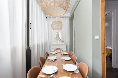 a dining room with a long table and chairs at Canela Homes BARCELONA RAMBLA CAT in Barcelona