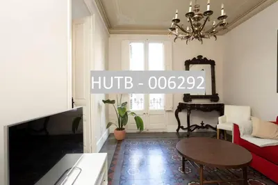 a living room with a table and a chandelier at Canela Homes BARCELONA RAMBLA CAT in Barcelona