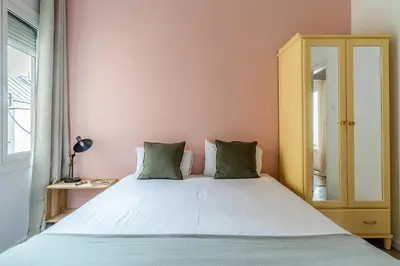 a bedroom with a large bed with a yellow cabinet at Canela Homes BARCELONA RAMCAT37 in Barcelona