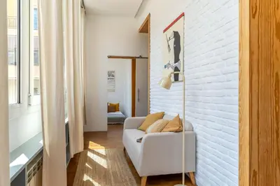 a white living room with a white brick wall at Canela Homes BARCELONA ART in Barcelona