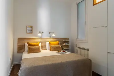a bedroom with a large bed with yellow pillows at Canela Homes BARCELONA ART in Barcelona