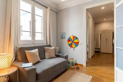 a living room with a couch and a window at Canela Homes BARCELONA DIPUTACIÓ in Barcelona