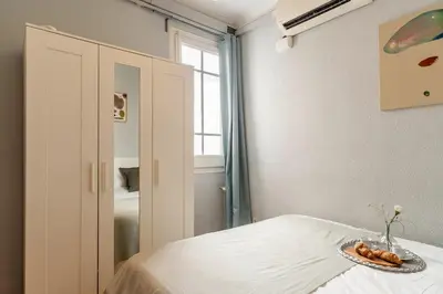 a bedroom with a bed with a plate of food on it at Canela Homes BARCELONA DIPUTACIÓ in Barcelona