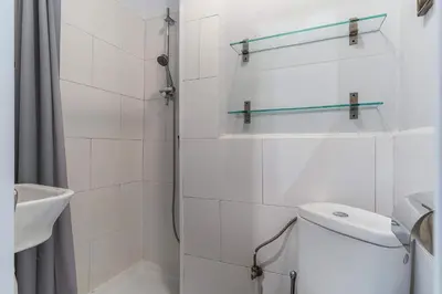 a white bathroom with a toilet and a shower at Canela Homes BARCELONA DIPUTACIÓ in Barcelona