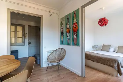 a bedroom with a bed and a table and a chair at Canela Homes BARCELONA BAILÉN in Barcelona