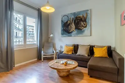 a living room with a couch and a table at Canela Homes BARCELONA ROSSELLÓ in Barcelona