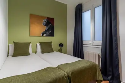 a bedroom with a bed with a picture of a dog at Canela Homes BARCELONA ROSSELLÓ in Barcelona