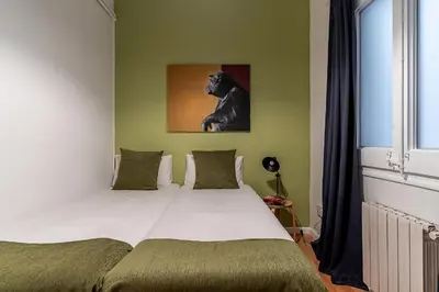 a bedroom with a bed with a picture of a dog at Canela Homes BARCELONA ROSSELLÓ in Barcelona