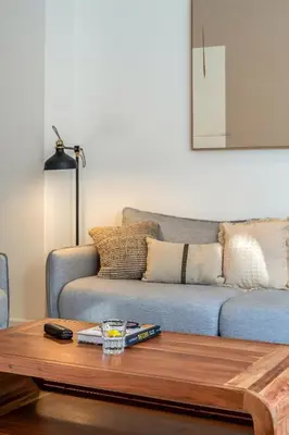 a living room with a couch and a coffee table at Canela Homes BARCELONA NINOT in Barcelona