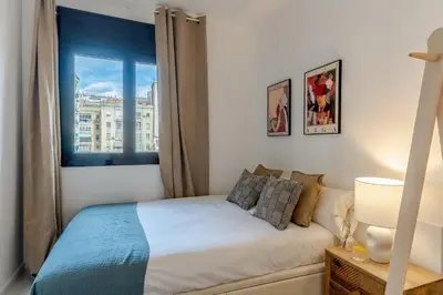 a bedroom with a bed and a window at Canela Homes BARCELONA NINOT in Barcelona
