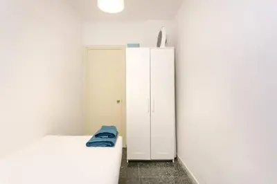a bedroom with a bed and a white cabinet at Canela Homes BARCELONA PARK GÜELL in Barcelona