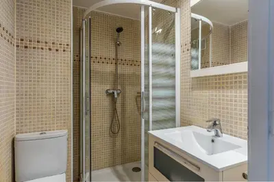 a bathroom with a shower and a toilet and a sink at Canela Homes COSTA CASTELLDEFELS in Castelldefels